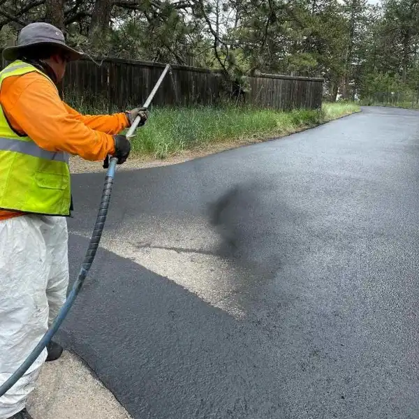 Asphalt driveway being sealcoated